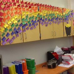 an office with many colorful pieces of paper on the wall