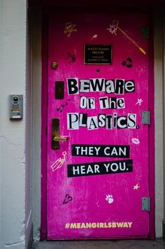 a pink door that has been decorated with stickers and words on it, saying beware of the plastics they can hear you