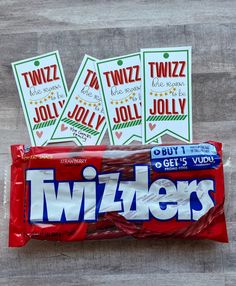 three twizzlers candy bars sitting on top of a wooden table next to each other