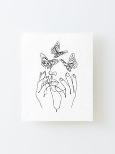 a black and white drawing of two hands holding butterflies