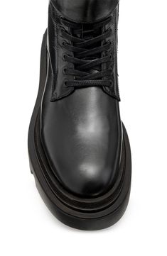 A treaded lug sole and decorative shaft strap bring a bold kick to the classic military boot. 6 1/4" shaft Lace-up style; side zip closure Leather upper and lining/synthetic sole Made in Portugal High-top Combat Boots With Lug Sole For Work, High-top Lug Sole Combat Boots For Work, Lug Sole Ankle Combat Boots For Workwear, Allsaints Leather Boots With Round Toe, Allsaints Leather Ankle Boots, Leather Ankle-high Combat Boots With Studded Outsoles, Ankle-high Leather Combat Boots With Studded Outsoles, Leather Combat Boots With Lug Sole, Leather Steel Toe Combat Boots For Work