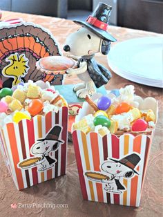 a table topped with popcorn bags filled with candy