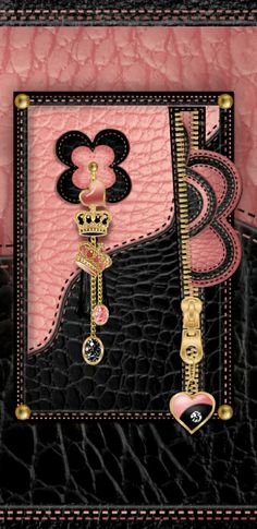 a pink and black purse with gold accents on it's side, featuring an embellishment