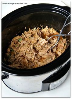 a slow cooker filled with pulled pork and potatoes, ready to be cooked in the crock pot