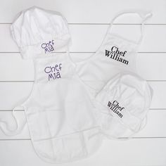 three personalized chef aprons are shown on a white wooden background with the words chef mia and chef william