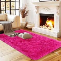 a living room with a pink rug and fireplace