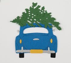 a blue car with a christmas tree on the roof is shown in front of a white background