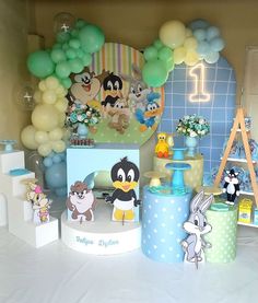 an assortment of toys and balloons on display at a children's birthday party or baby shower