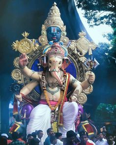 a statue of the god ganesh in front of a crowd