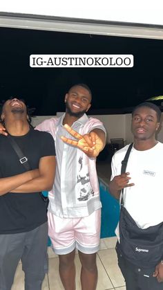 three men standing next to each other in front of a sign that says ig - austitoko koloo