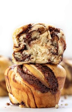 two chocolate swirl muffins stacked on top of each other