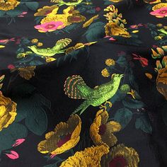 a black and yellow floral print fabric with green birds on the top, surrounded by flowers