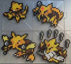 several pixel art pieces are arranged on a table top, each with different pokemon characters