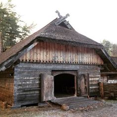 an old wooden building with two crosses on the roof and a cross above it's door