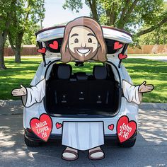 the car is decorated with an image of jesus on it's trunk and features hearts