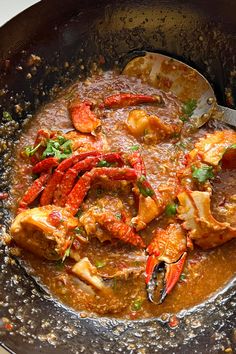 a skillet filled with cooked lobsters and sauce