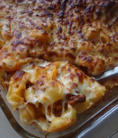 a casserole dish with cheese and meat in it