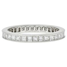 Featuring princess cut diamonds channel set fully around Weighing approximately 1.26 carat total G color with VS clarity With high polish finish Stamped for platinum Fully signed for Tiffany & Co. Circa: 2000s Ring size: 5 and not sizable Measures north to south 2.5 mm and sits 2.0 mm high Total weight: 3.0 grams Stock Number: We-12437 Memory Ring, Princess Cut Diamond, Tiffany And Co, Diamond Rings Bands, Channel Set, Princess Cut Diamonds, Princess Cut, Tiffany & Co., Band Ring