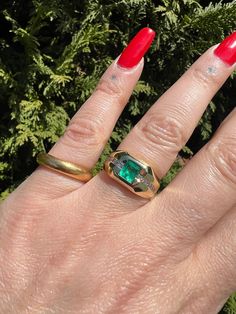 This gorgeous vintage ring features a 1 carat natural columbian emerald, flush set into 14k yellow gold. It is accented by two rows of approx .36 carats of VS2-G channel set diamonds, there are 6 on either side of the emerald. It is in great vintage condition showing light age and wear... expected with vintage jewelry. Ready to wear! and would make an amazing gift for anyone born in the month of May. Size US 7 1/8-7 1/4, and is sizable within reason by your jeweler Weighs approx 10 grams Emerald measures approx 4.97mm x 5mm Each diamond measures approx 2.1mm in diameter  ring width measures approx 10.15 and tapers down to 3.4mm setting measures approx 3.8mm high  Follow along on instagram @farewelltrading to keep up with my latest travel, finds, and first looks at new inventory. Each order Heirloom Yellow Gold Emerald Ring With Center Stone, Classic 14k Gold Green Diamond Ring, Classic Green 14k Gold Diamond Ring, Vintage Emerald Ring With Vvs Diamond, Classic Green Diamond Ring In 14k Gold, Timeless 14k Gold Emerald Ring With Vvs Clarity, Classic Emerald Ring With Baguette Cut, Timeless Yellow Gold Signet Ring With Emerald, Timeless Yellow Gold Emerald Signet Ring