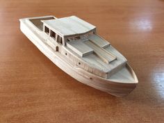 a toy boat is sitting on a wooden table