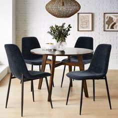 a dining table with four chairs around it