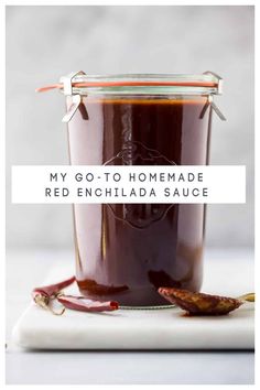 red enchilada sauce in a glass jar with the words, my go - to homemade red enchilada sauce