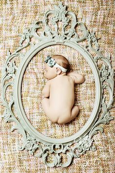 a baby is laying down in a frame