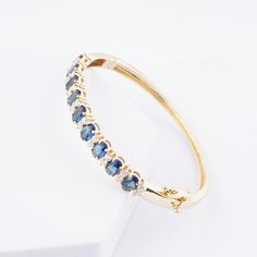 Oval-cut Blue Sapphire Bangle Bracelet, 14k Yellow Gold Plated Half Eternity Bangle, Sapphire Bracelet, Anniversary Gifts, Handmade jewelry * Material: High Quality Solid 925 Sterling Silver * Finish: Sterling Silver ∙ 14K Gold * I N F O R M A T I O N * Every item is tastefully wrapped and presented in lovely jewelry boxes. Reusable and biodegradable, our jewelry boxes * Are you interested in your own design or looking for advice? Do not hesitate to contact us! We take pride in our quick respons Oval Fine Jewelry Bracelet For Anniversary, Oval Gemstone Bangle In Fine Jewelry Style, Oval Jubilee Bracelet For Anniversary, Oval Gemstone Bracelets For Anniversary, Blue Oval Bracelet For Anniversary, Blue Oval Bracelets For Anniversary, Gold Oval Bracelet With Gemstone, Oval Gold Bracelet For Wedding, Oval Fine Jewelry Bangle As Gift