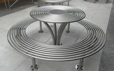 three metal tables sitting on top of each other