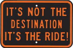 an orange and black sign that says it's not the destination it's the ride