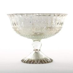 Create a stunning DIY wedding arrangement for a rustic glam look with this gorgeous silver mercury glass compote bowl. Perfect for any event centerpiece or home decorating, this pedestal is hollow to allow for extra room for stems and vase fillers. *For added stability, you may need to remove pads from bottom of pedestal* Silver 5" Tall x 7" Wide Mercury Glass Hand Wash Only Do NOT Use Harsh Chemicals Flower Bowl Centerpiece, Compote Bowl Centerpiece, Bowl Pedestal, Bowl Centerpiece, Pedestal Vase, Glass Centerpieces, Flower Bowl, Vase Fillers, Gorgeous Christmas