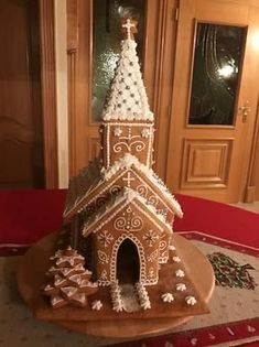 a large gingerbread house with a clock on top