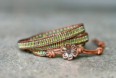 a close up of two bracelets with beads and flowers on the end of them