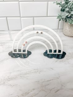 three white and black rings sitting on top of a marble counter