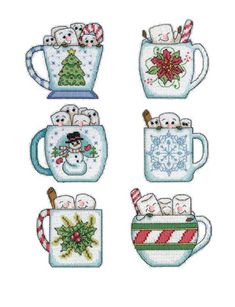 four cross stitch mugs with christmas decorations on them