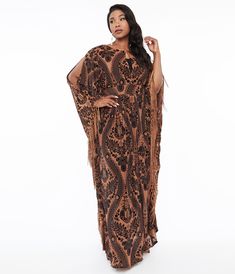 This beautiful 1960s style caftan is crafted in a stunning black & nude fabric that features an embossed floral print throughout. Outfitted with a sultry front button keyhole and framed with long cold shoulder flutter sleeves accented with fringe. Complete with a back zipper!Available in sizes XS-5X while supplies last.Style Is Semi-Sheer, Slip Sold Separately. Bohemian Brown Evening Dress, Nude Fabric, 1960s Style, Vintage Plus Size, 1960s Fashion, Flutter Sleeves, Flutter Sleeve, Unique Vintage, Cold Shoulder