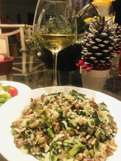 a salad and wine glass on a table