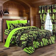 a bed room with a neatly made bed covered in green and black comforter sets