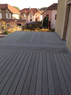 a wooden deck with houses in the background