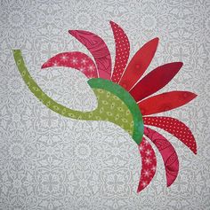 a red and green flower on a white background