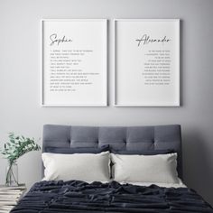 two framed posters on the wall above a bed