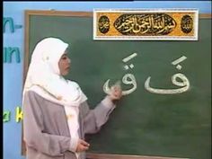 a woman writing on a blackboard in arabic