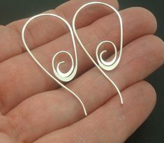 "These spiral earrings are handmade with sterling silver wire by me in a pull through style. They've been flattened at the tip, which adds a nice touch. They are light and comfortable to wear and get a lot of compliments. I've taken solid sterling silver wire and shaped it, hammered it and tumble polished it for durability, shine and springiness. I have carefully smoothed the rough edges off of the end of the wire that goes through your ear. These earrings are a bit over 1-3/4\" (4.7 cm) long an Handmade Spiral Sterling Silver Wrap Earrings, Adjustable Spiral Sterling Silver Wrap Earrings, Stick Earrings, Spiral Earrings, Hammered Sterling Silver, Disc Pendant, Pull Through, Silver Wire, Beautiful Earrings