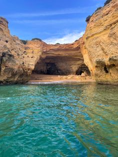 the water is crystal blue and green in this photo, it looks like an ocean cave