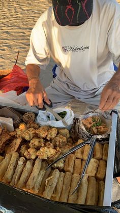 a man is preparing food on the beach