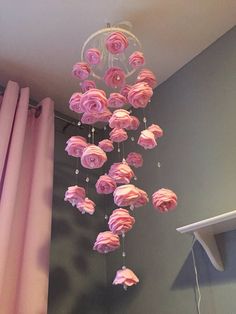 pink roses hanging from the ceiling in a bedroom