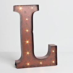 the letter j is made out of metal and has lights on it's sides