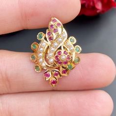 Boasting a sophisticated multicoloured jadau ring in 22ct gold, this timeless piece offers an alluring floral design. Weighing 4.4 GMs, its combination of style and resilience make it an apt accessory for any ensemble or event. Handcrafted with expertise, it promises a high-quality finish. Price Breakup Summary Component Rupees % of Total 22k Gold 21,384 74.0% Stones & Beads 1,848 6.4% Making Charges 3,849 13.3% Taxes (GST) 812 3.0% Total 28,894 100.0% View Detailed Price Breakup Watch Video Here Polki Rings Design, Polki Rings, Emerald Ring Design, Jewel Design, Antique Gold Earrings, Gold Bridal Jewellery Sets, Flower Rangoli, Pearl Necklace Set