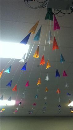 multicolored kites are hanging from the ceiling