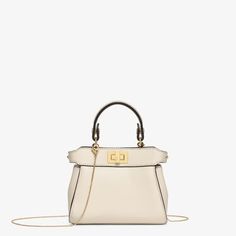 Iconic Nano Peekaboo bag with every detail recreated. Featuring a leather-lined interior, two compartments separated by a stiff partition, a removable handle with two press studs and the classic twist lock. It can be carried by hand or worn cross-body thanks to the fine chain shoulder strap. Made of camellia-coloured nappa leather. Gold-finish metalware. Made in Italy. One Size Pink Fendi, Peekaboo Bag, Fendi Pink, Fendi Shoulder Bag, Fendi Peekaboo, Lock It, Shoulder Strap Bag, Travel Bags For Women, Canvas Shoulder Bag